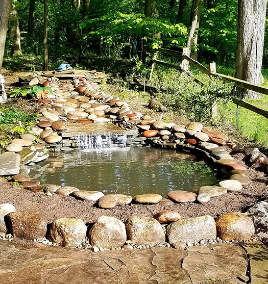 Residential pond with pond supplies from Pond Place of Michigan